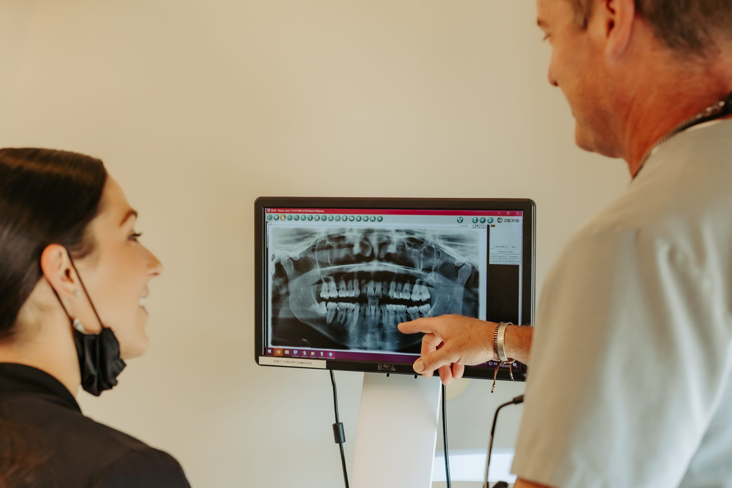 Woman at a dentist appointment speaking to dentist and hygienist