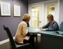 Woman speaking with staff at Dodge City Dental Care